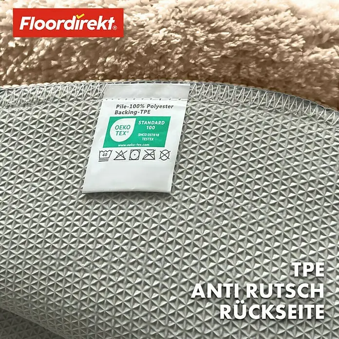 Floordirekt Badteppich Sky - 120 x 120 cm, Beige, 100% Polyester - Detailansicht der rutschfesten Rückseite eines "Floordirekt" Teppichs mit Öko-Tex Standard 100 Zertifizierung.