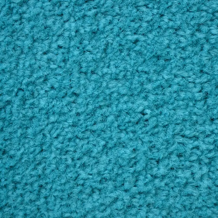 Fußmatte Monochrom - Türkis, 90 x 60 cm, 100 % Polyamid - Nahaufnahme eines türkisfarbenen Teppichs mit weicher, zotteliger Textur, ideal für Wohnräume, um Wärme und Komfort zu vermitteln.
