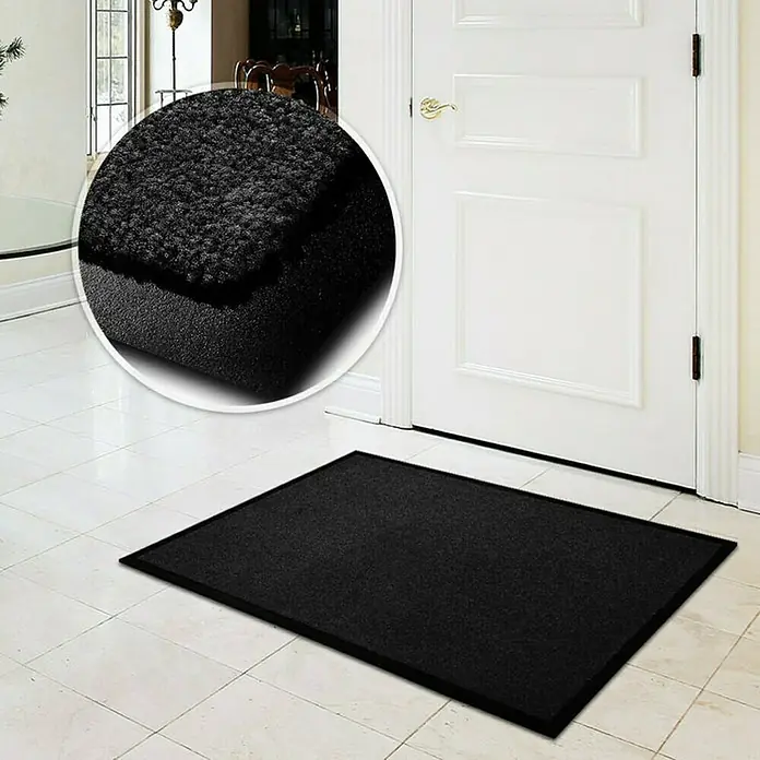 Fußmatte Monochrom - Schwarz, 180 x 60 cm, 100 % Polyamid - Fußmatte in Schwarz vor einer weißen Tür, ideal für den Innenbereich, um Sauberkeit zu gewährleisten. Die Matte fängt Schmutz effektiv auf.