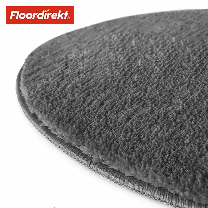 Floordirekt Badteppich Sky - 120 x 120 cm, Dunkelgrau, 100% Polyester - Nahaufnahme eines grauen, runden Teppichs von Floordirekt, der eine weiche Textur und eine dezente Bordüre aufweist.