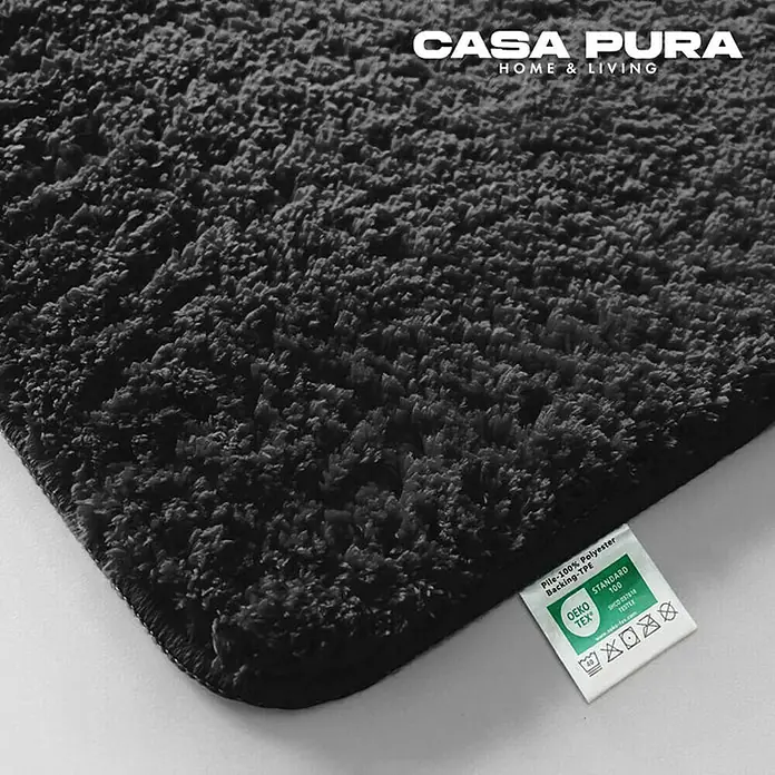 Floordirekt Badteppich Sky - 60 x 50 cm, Schwarz, 100% Polyester - Nahaufnahme eines grauen Casa Pura Teppichs mit Etikett, ideal für ein gemütliches Zuhause.