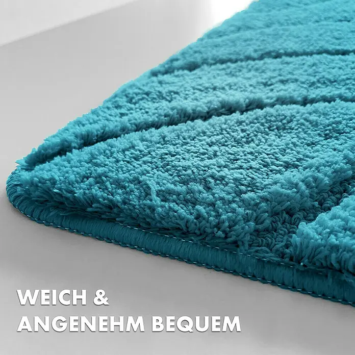 Floordirekt Badteppich Maris - 120 x 60 cm, Türkis, 100% Polyester - Nahaufnahme einer türkisfarbenen Badematte mit flauschiger Textur und Randdetails, die zum Komfort einladen.