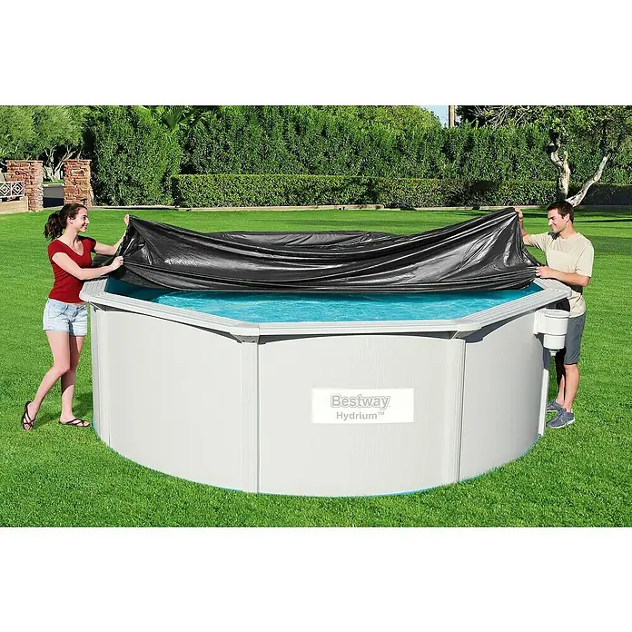 Bestway Pool-Abdeckplane - Durchmesser: 401 cm, Material: Kunststoff - Zwei Personen legen eine schwarze Poolabdeckung auf einen runden Bestway Hydrium Pool im Garten.