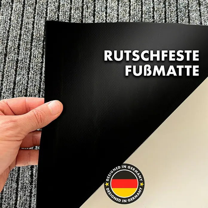 Fußmatte Dura - Beige, 120 x 90 cm, 100 % Polypropylen - Bild einer rutschfesten Fußmatte mit dem Aufdruck "Designed in Germany". Die Matte ist schwarz und hat eine helle Unterseite.