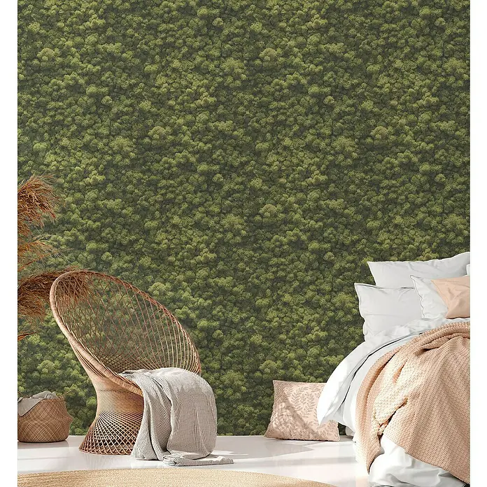 A.S. Création Pintwalls 2 Vliestapete Mooswand - Grün, Floral, 10,05 x 0,53 m - Schlafzimmer mit einer Mooswand, einem Rattansessel und einem gemütlichen Bett.
