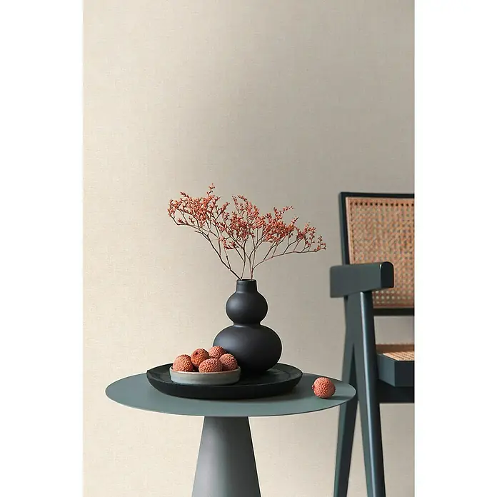 A.S. Création Metropolitan Stories Hot Spots Vliestapete - Creme-Beige, Uni, 10,05 x 0,53 m - Stillleben-Arrangement mit einer eleganten schwarzen Vase, Trockenblumen und einer Schale mit exotischen Früchten auf einem stilvollen Beistelltisch.