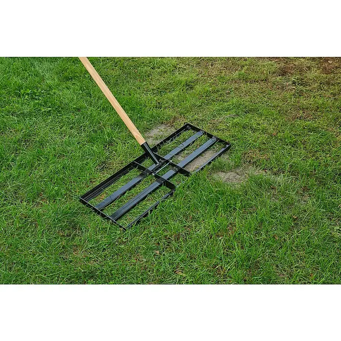Gardol Rasenrakel ohne Stiel - 24,5 cm, Stahl, Passend für: Gerätestiele mit Konus, Ø 28 mm - Eine Rasenwalze mit hölzernem Griff liegt auf grünem Gras. Die Walze ist schwarz und hat ein rechteckiges Design für die Gartenarbeit.