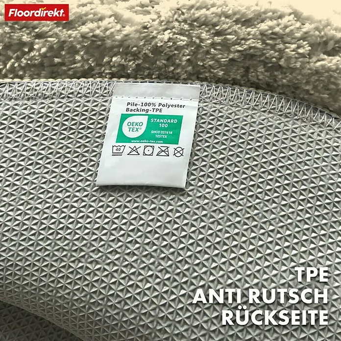Floordirekt Badteppich Maris - 120 x 120 cm, Ivory, 100% Polyester - Detailansicht der rutschfesten TPE-Rückseite eines Teppichs von Floordirekt, mit OEKO-TEX® Standard 100 Zertifizierung für hohe Qualität.