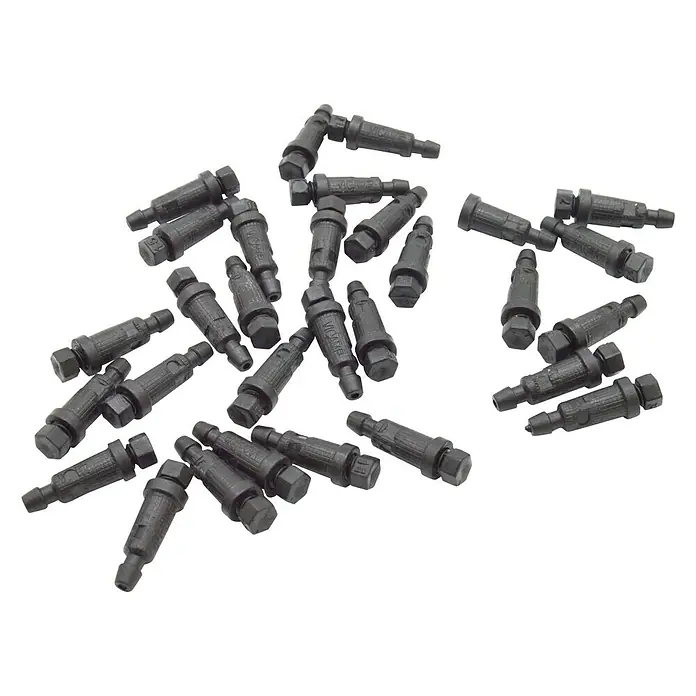 Gotero lineal - 2 l/h, 25 ud. - Primer plano de una variedad de inyectores de combustible negros, dispuestos desordenadamente sobre una superficie blanca.