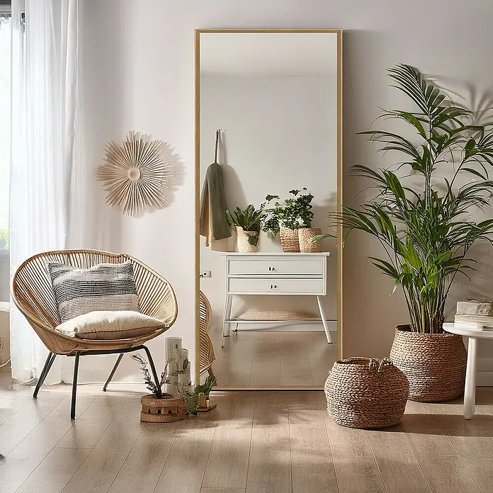 Espejo de pared Tampere - 43 x 133 cm, Roble oscuro - Un espejo de cuerpo entero con marco dorado se encuentra en una habitación luminosa, reflejando con estilo el interior y destacando la decoración.