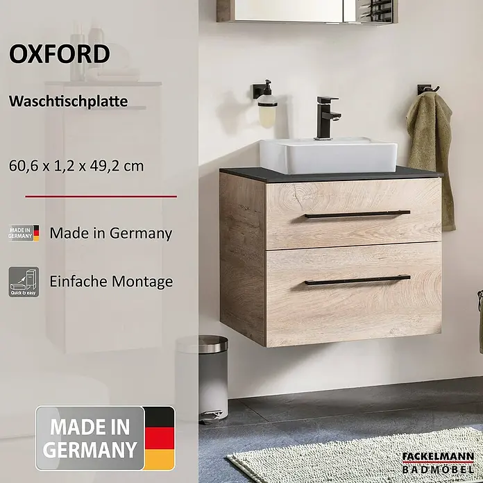 Fackelmann Oxford Waschtischplatte - Schwarz Schieferoptik, B x T x S: 606 x 492 x 12 mm - Das Bild zeigt einen modernen Oxford Waschtischunterschrank in Holzoptik mit zwei Schubladen, einem schwarzen Waschbecken und Armaturen.