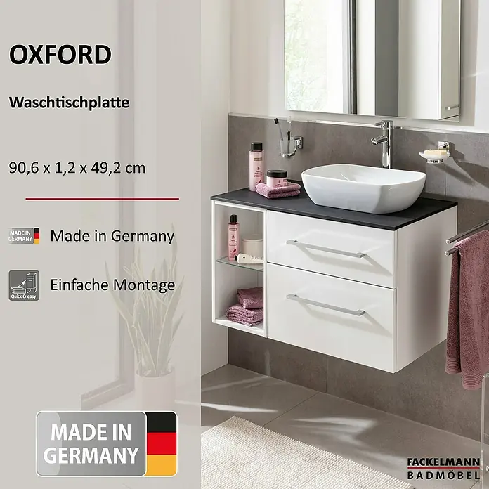 Fackelmann Oxford Waschtischplatte - Schwarz Schieferoptik, B x T x S: 906 x 492 x 12 mm - Produktfoto eines weißen Oxford Waschtischunterschranks mit Schubladen und offenem Regal, montiert im Badezimmer.