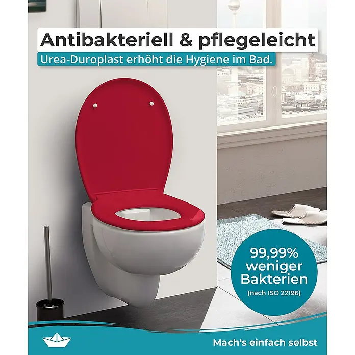 Calmwaters WC-Sitz Original - Duroplast, Rot, Mit Absenkautomatik - Das Bild zeigt eine Nahaufnahme einer weißen Toilette mit einem roten antibakteriellen und pflegeleichten Urea-Duroplast-Sitz für erhöhte Hygiene.