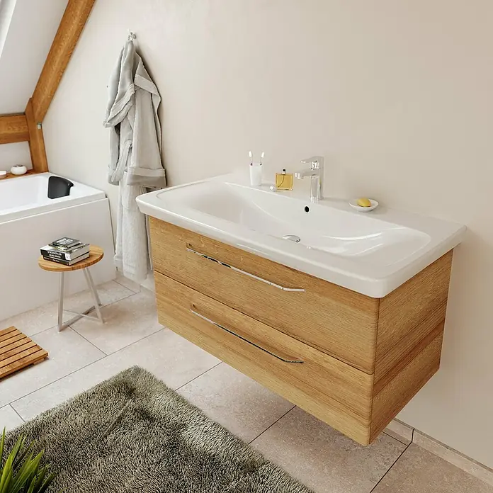 Fackelmann Milano Waschtisch - Weiß, L x B x H: 107,5 x 17 x 54,5 cm - Bild eines modernen Waschtischunterschranks aus hellem Holz mit zwei Schubladen und einem weißen Waschbecken. Ideal für ein stilvolles Badezimmer.