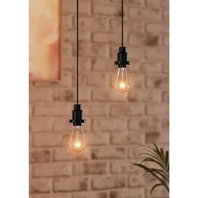 Osram Portalámparas de cuerda Vintage 1906 Pendulum Black - Negro, 200 cm, 60 W, E27 - Dos bombillas Edison con enchufes negros cuelgan frente a una pared de ladrillos, brindando una luz cálida y un ambiente elegante.