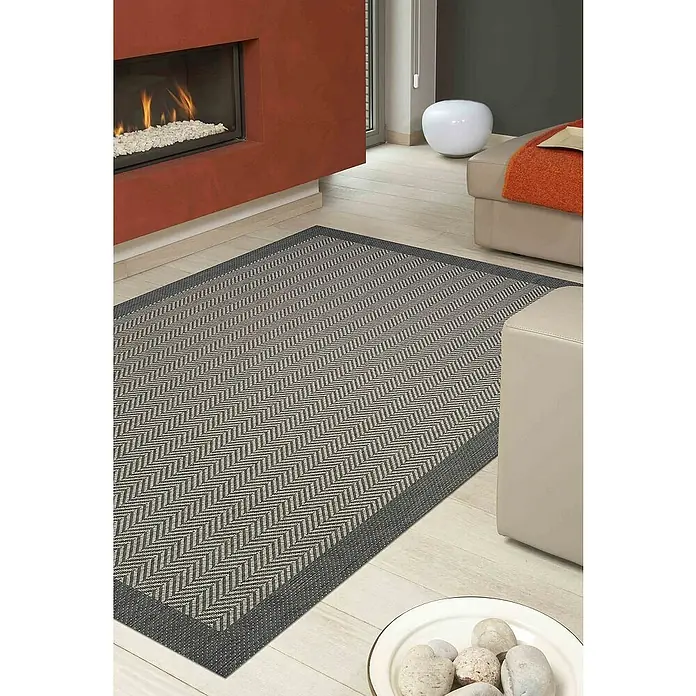 Dekoria Flachgewebeteppich - grau, 170 x 120 cm - Moderner Teppich mit Fischgrätenmuster in Grau und Beige neben einem Kamin und einer Sitzgruppe.