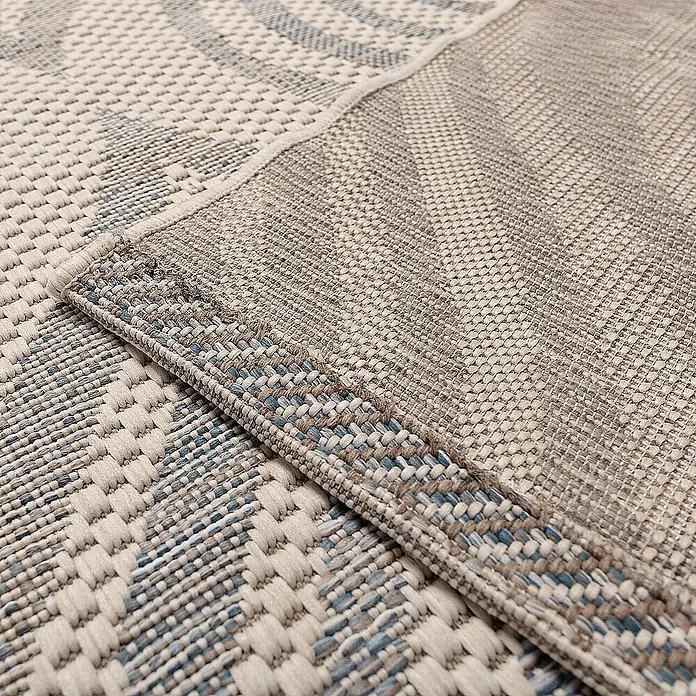 Dekoria Flachgewebeteppich - creme, blau, 290 x 200 cm - Nahaufnahme eines zweifarbigen Teppichs mit komplexen Webmustern in Beige- und Blautönen, der Textur und Design hervorhebt.