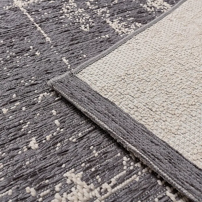 Dekoria Flachgewebeteppich - grau, 290 x 200 cm - Nahaufnahme eines modernen grauen Teppichs mit abstraktem Muster und gewebter Textur.