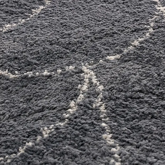 Dekoria Flachgewebeteppich - grau, 230 x 160 cm - Detailaufnahme eines grauen Teppichs mit weißem geometrischen Muster, der Textur und Design hervorhebt.