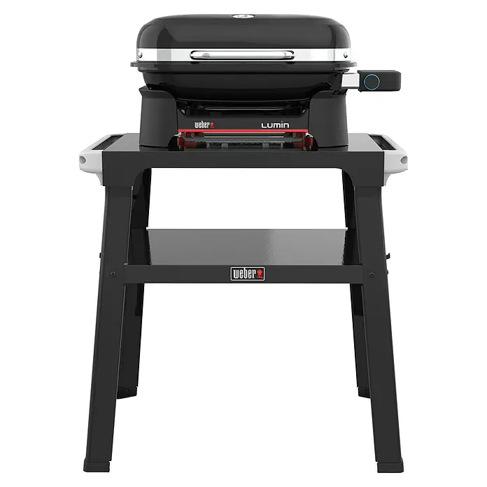 Weber Compact Elektrogrill Lumin Compact mit Grilltisch - Grillfläche (B x T): 43 x 28 cm, 2,2 kW - Das Foto zeigt den Weber Lumin Elektrogrill mit seinem stilvollen Unterwagen, perfekt für jede Terrasse oder Balkon.