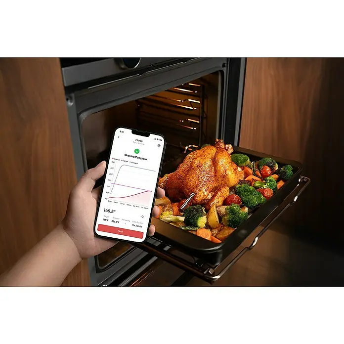 Typhur Grill-Thermometer Sync One - 2 -tlg., Kabellos; Verbindung via Bluetooth oder Wi-Fi - Ein Smartphone zeigt die Kochtemperatur eines Bratens an, der im Ofen mit einem Thermometer zubereitet wird.