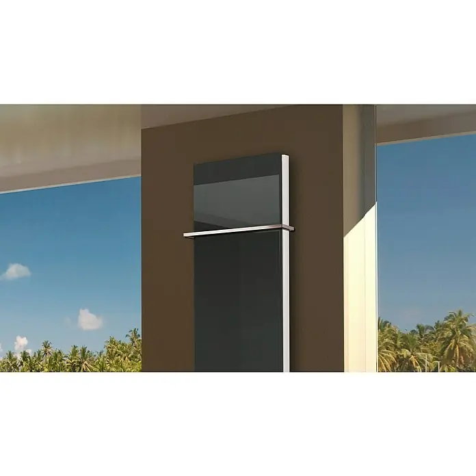 Badheizkörper Montevideo - B x H: 470 x 1.800 mm, Nennleistung: 1.964 W, Anthrazit, 1 x Halter 15mm - Ein eleganter, moderner Handtuchwärmer aus Glas und Metall hängt an einer braunen Wand, mit Ausblick auf eine tropische Landschaft.