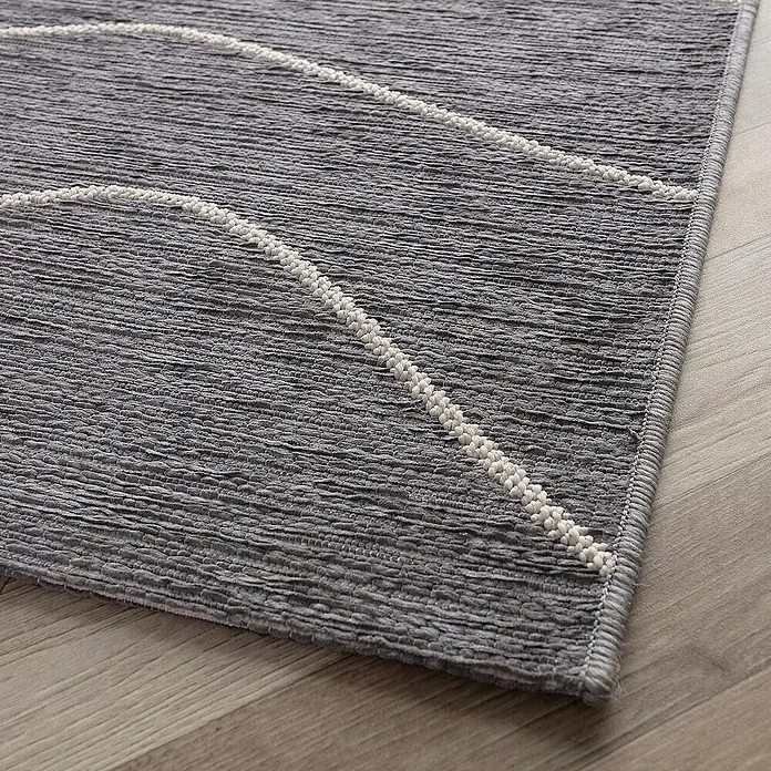 Dekoria Flachgewebeteppich - grau, 230 x 160 cm - Detailaufnahme eines grauen Teppichs mit weißen Akzenten und einer strukturierten Oberfläche, die eine moderne Ästhetik verleiht.