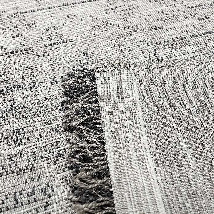 Dekoria Flachgewebeteppich - grau, 170 x 120 cm - Nahaufnahme eines strukturierten, grauen Teppichs mit Fransen, der eine robuste und stilvolle Textur zeigt.