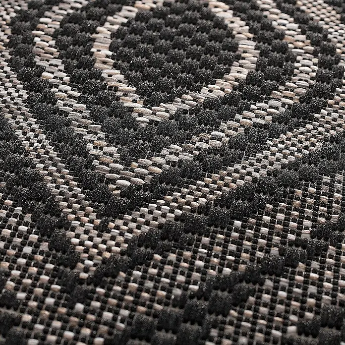 Dekoria Flachgewebeteppich - schwarz, 170 x 120 cm - Nahaufnahme eines strukturierten Teppichs mit geometrischem Muster in Schwarz- und Naturtönen. Die Textur betont die handwerkliche Qualität des Teppichs.