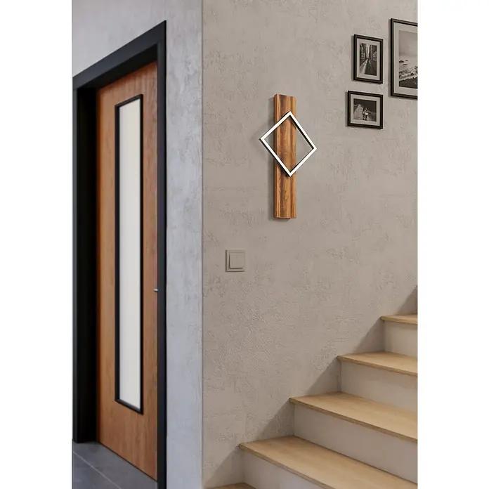 Eglo Boyal Aplique de pared LED - 13 W, L x Al: 30,5 x 56 cm, Marrón, Blanco cálido - Primer plano de una moderna lámpara de pared de madera con una inserción metálica cuadrada, en un interior elegante con escalera.