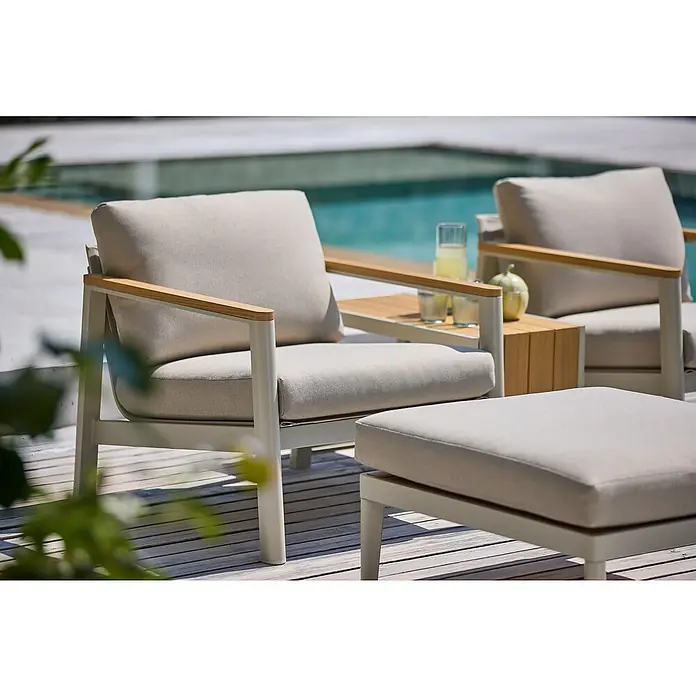 Sunfun Solo Loungesessel - B x T x H: 73 x 84,5 x 62,5 cm, Aluminium, Olefin, Light-Greige - Nahaufnahme von zwei weißen Sesseln mit beigen Polstern und Holzelementen neben einem Pool, die zum Entspannen einladen.