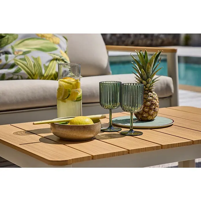 Sunfun Solo Loungetisch - B x T x H: 99,5 x 57 x 32,5 cm, Aluminium, Light-Greige - Stillleben mit Zitrusfrüchten, Ananas und stilvollen grünen Gläsern auf einem modernen Gartentisch.