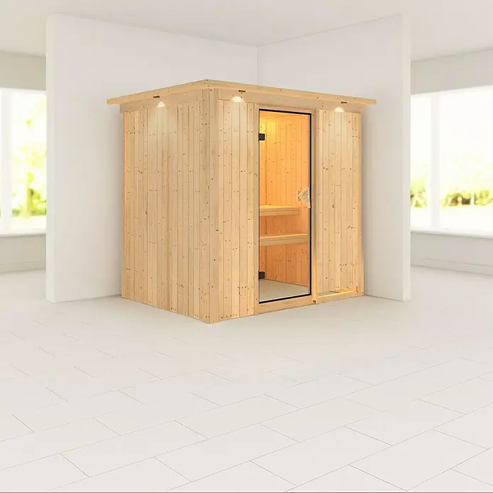 Karibu Elementsauna Fanja - Ohne Ofen, Mit Dachkranz und Beleuchtung, L x B x H: 210 x 165 x 192 cm - Holzsauna mit Glastür und eingebauten Lichtern in einem hellen Raum. Die Sauna bietet Entspannung und Wellness für zu Hause.