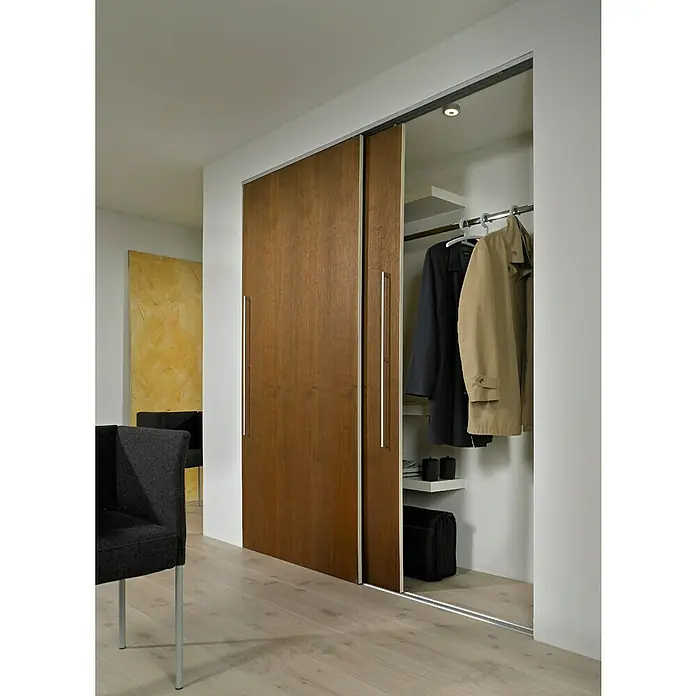 Hettich Laufschiene SlideLine 16 - Länge: 2.000 mm, Traglast: 60 kg - Moderne Schiebetüren vor einem begehbaren Kleiderschrank mit Holzstruktur und langen Griffen. Ideal für mehr Stauraum und Ordnung im Schlafzimmer.