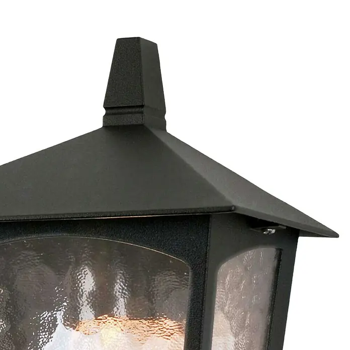Elstead Außenwandleuchte York - 60 W, 14 x 28 x 28 cm, Schwarz, IP23 - Nahaufnahme einer schwarzen Aussenlaterne mit Strukturglas. Das Licht scheint warm durch das Glas und betont die elegante Form.