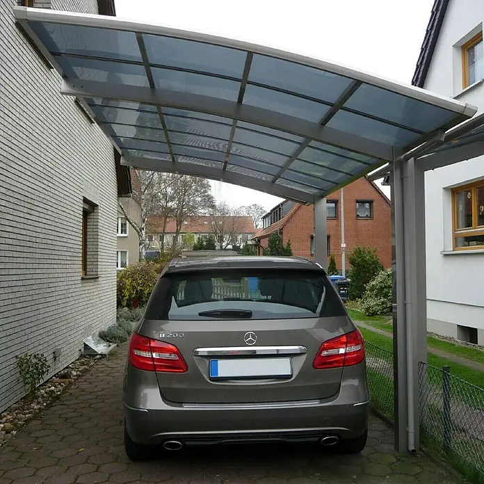 Ximax Carport Portoforte 80 - Außenmaß inkl. Dachüberstand (B x T): 2,7 x 4,95 m, Einzelcarport, Edelstahloptik, Schneelast: 100 kg/m² - Grauer Mercedes-Benz B 200 unter einem Carport mit transparentem Dach, das Schutz vor Witterungseinflüssen bietet und das Fahrzeug sauber hält.