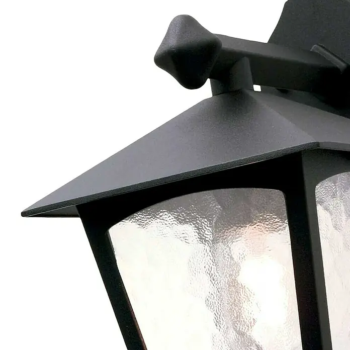 Elstead Außenwandleuchte York - 60 W, 22,5 x 31 x 31 cm, Schwarz, IP23 - Nahaufnahme einer schwarzen Außenlaterne mit dekorativem Oberteil und strukturiertem Glas, die eine subtile Beleuchtung für den Außenbereich bietet.