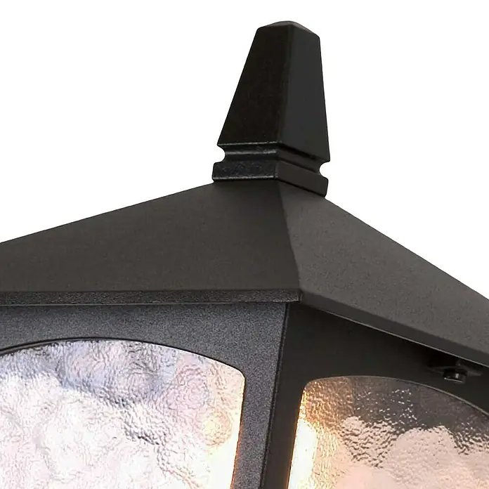 Elstead Außenwandleuchte York - 60 W, 23 x 43,5 x 43,5 cm, Schwarz, IP23 - Nahaufnahme einer eleganten, schwarzen Außenleuchte mit dekorativem Aufsatz und strukturiertem Glas, die ein warmes Licht ausstrahlt.