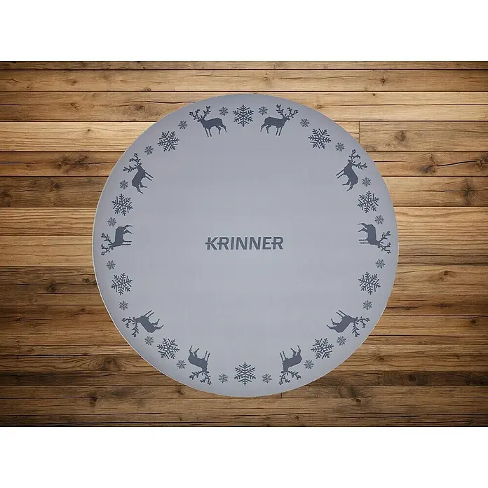 Krinner Dekoartikel - L x B x H: 60 x 60 x 0,7 cm, Grau - Graue, runde Tischdecke mit Rentier- und Schneeflockenmuster. Die Marke "KRINNER" ist in der Mitte zu sehen.