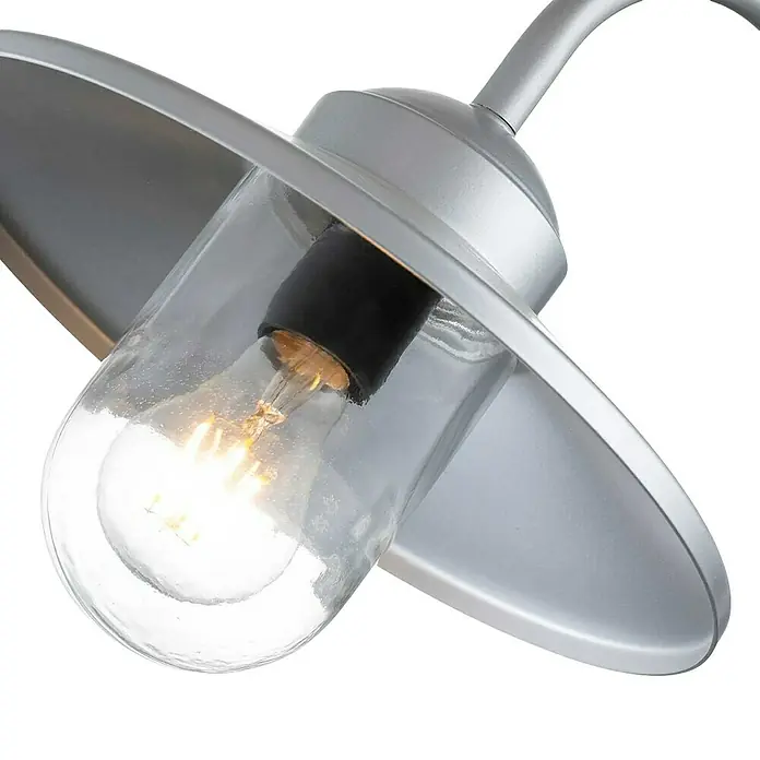 Elstead Außenwandleuchte Klampenborg - 50 W, 42 x 27,5 x 25,5 cm, Silber, IP44 - Nahaufnahme einer stilvollen Außenleuchte mit einem klaren Glasschirm, der eine helle Glühbirne umgibt. Silbernes Metallgehäuse sorgt für einen modernen Touch.