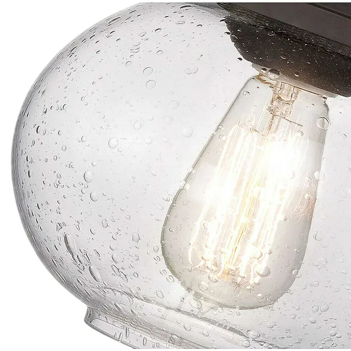 Elstead Wandleuchte Trilogy - 60 W, L x B x H: 22,5 x 19,9 x 24,1 cm, Schwarz, E27 - Nahaufnahme einer stilvollen Leuchte mit einer klaren Glaskugel und einer dekorativen Edison-Glühbirne.