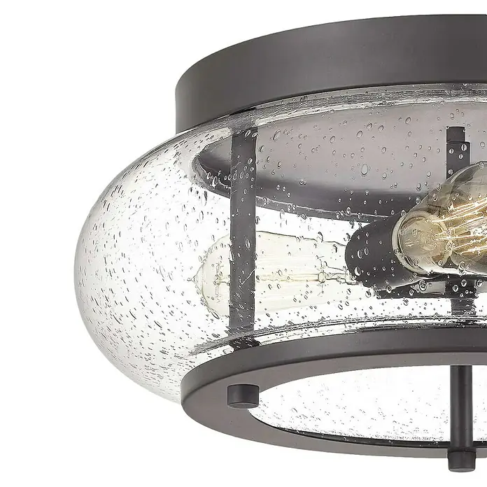 Elstead Deckenleuchte Trilogy - 60 W, L x B x H: 40,6 x 40,6 x 18 cm, Altbronze, E27 - Nahaufnahme einer modernen Deckenleuchte mit klarem Glasschirm und dunklem Metallrahmen. Das Licht wird von mehreren Glühbirnen im Inneren erzeugt.