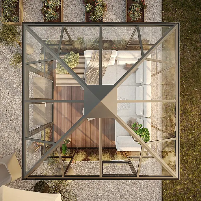 KGT Gewächshaus PaviLux 3,5 - Außenmaß inkl. Dachüberstand (B x T): 350 x 350 cm, 4 mm, Anthrazit-grau, Einscheibensicherheitsglas - Luftaufnahme eines eleganten Gewächshauses mit stilvoller Inneneinrichtung und umlaufendem Kiesweg, der sich nahtlos in die Umgebung einfügt.