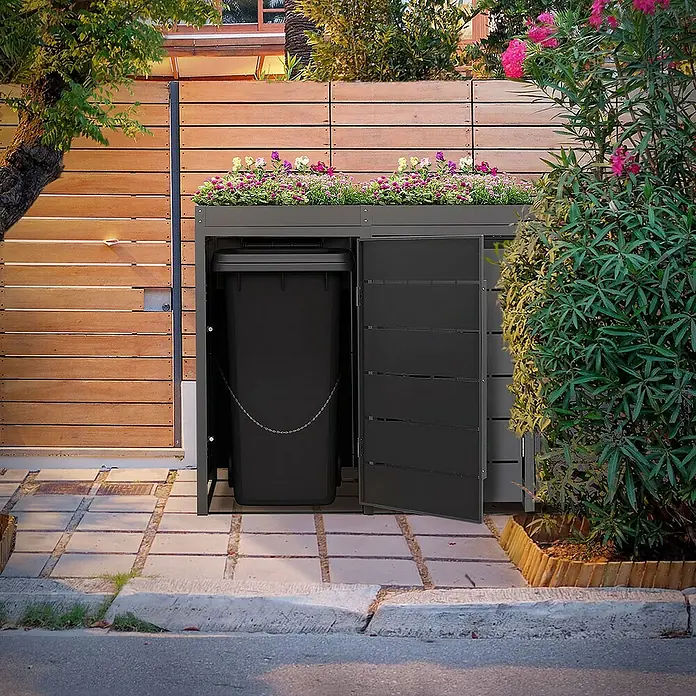 ML-Design Mülltonnenbox Mülltonnencontainer mit Pflanzdach für 4 Tonnen 120 oder 240 Liter - 80 x 80 cm, Stahl, Anthrazit, Geeignet für Anzahl Mülltonnen: 4 Stk. - Schwarze Mülltonne in einem grauen Mülltonnenbox mit Pflanzbeet oben drauf. Das Produkt ist in einem Garten aufgestellt.