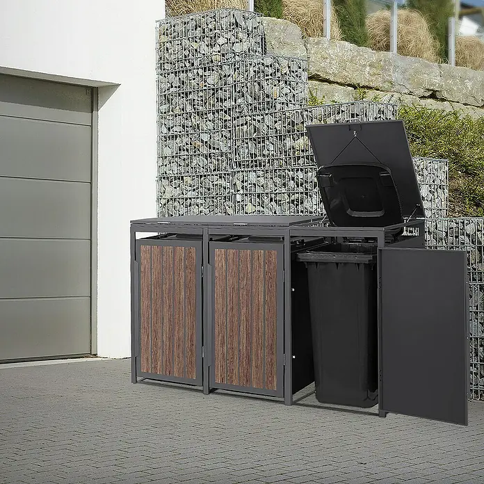 ML-Design Mülltonnenbox Mülltonnencontainer mit Klappdeckel/Tür für 3 Tonne 120 oder 240 Liter - Stahl, Eiche dunkel, Geeignet für Anzahl Mülltonnen: 3 Stk. - Mülltonnenbox mit Holztüren und Metallrahmen vor einer Gabionenwand, die eine stilvolle Lösung für die Mülltonnenaufbewahrung bietet.