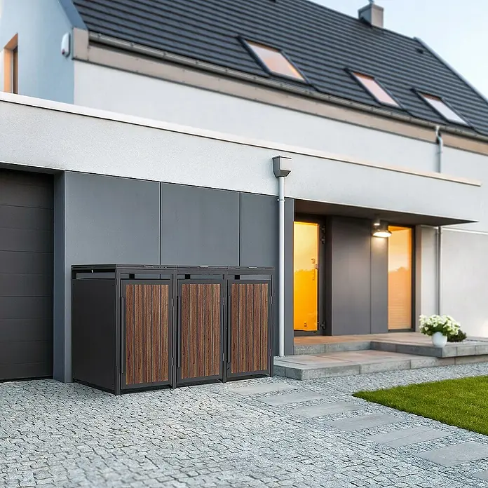 ML-Design Mülltonnenbox Mülltonnencontainer mit Klappdeckel/Tür für 3 Tonne 120 oder 240 Liter - Stahl, Eiche dunkel, Geeignet für Anzahl Mülltonnen: 3 Stk. - Mülltonnenbox aus dunklem Metall und Holz vor einem modernen Haus, stilvolle Lösung für die Müllentsorgung im Freien.