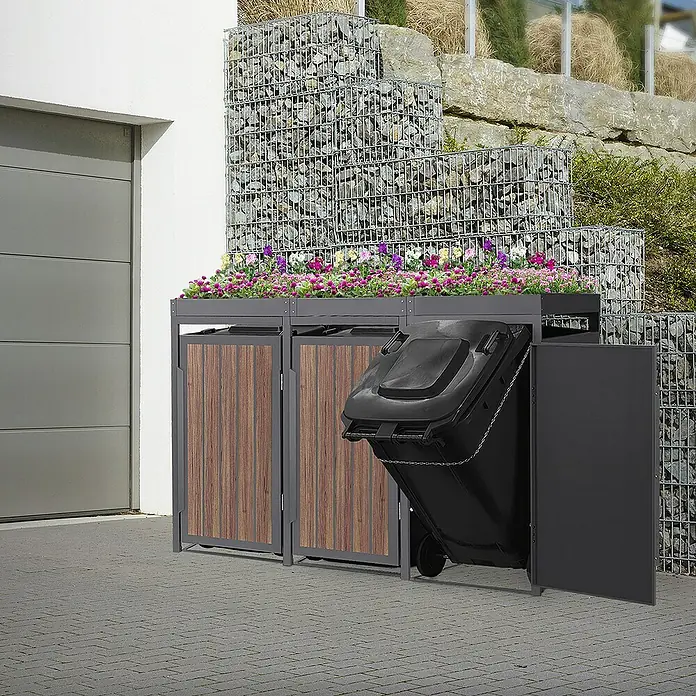 ML-Design Mülltonnenbox Mülltonnencontainer mit Pflanzdach für 3 Tonnen 120 oder 240 Liter - Stahl, Eiche dunkel, Geeignet für Anzahl Mülltonnen: 4 Stk. - Eine Mülltonnenbox mit integriertem Pflanzkasten und einer Tür, die eine Mülltonne enthält, vor einem Haus.