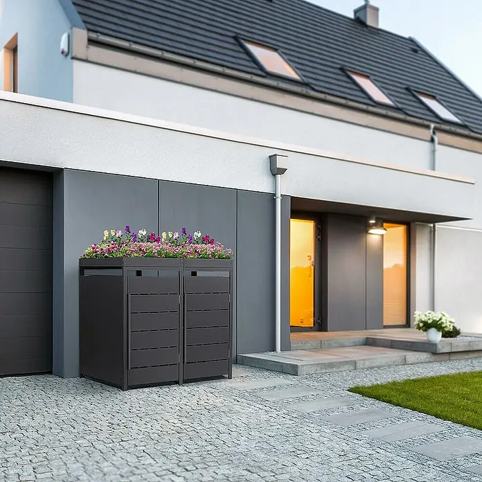 ML-Design Mülltonnenbox Mülltonnencontainer mit Pflanzdach für 2 Tonnen 120 oder 240 Liter - 80 x 80 cm, Stahl, Anthrazit, Geeignet für Anzahl Mülltonnen: 2 Stk. - Mülltonnenbox mit Bepflanzung auf der Oberseite vor modernem Haus. Die Box ist dunkelgrau und hat horizontale Streben.