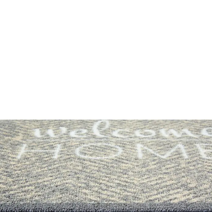 Schmutzfangmatte Miabella - Grau, 70 x 50 cm, 100 % Polyamid - Fußmatte mit der Aufschrift "Welcome Home" in Weiß auf einem grau-weiß melierten Zickzackmuster. Perfekt für den Eingangsbereich.