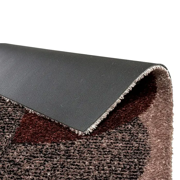 Fußmatte Manhatten - Beige/Terracotta, 70 x 50 cm, 100 % Polyamid - Nahaufnahme einer braunen Fußmatte mit Muster und schwarzer rutschfester Unterseite. Ideal für den Innenbereich und zur Schmutzabweisung.